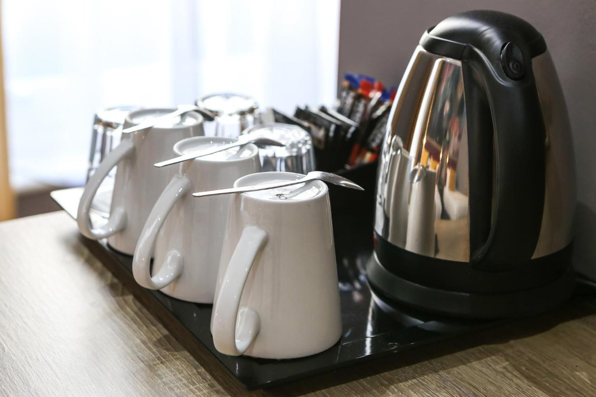 a row of white and black appliances on a counter at Comfort Inn Victoria in London