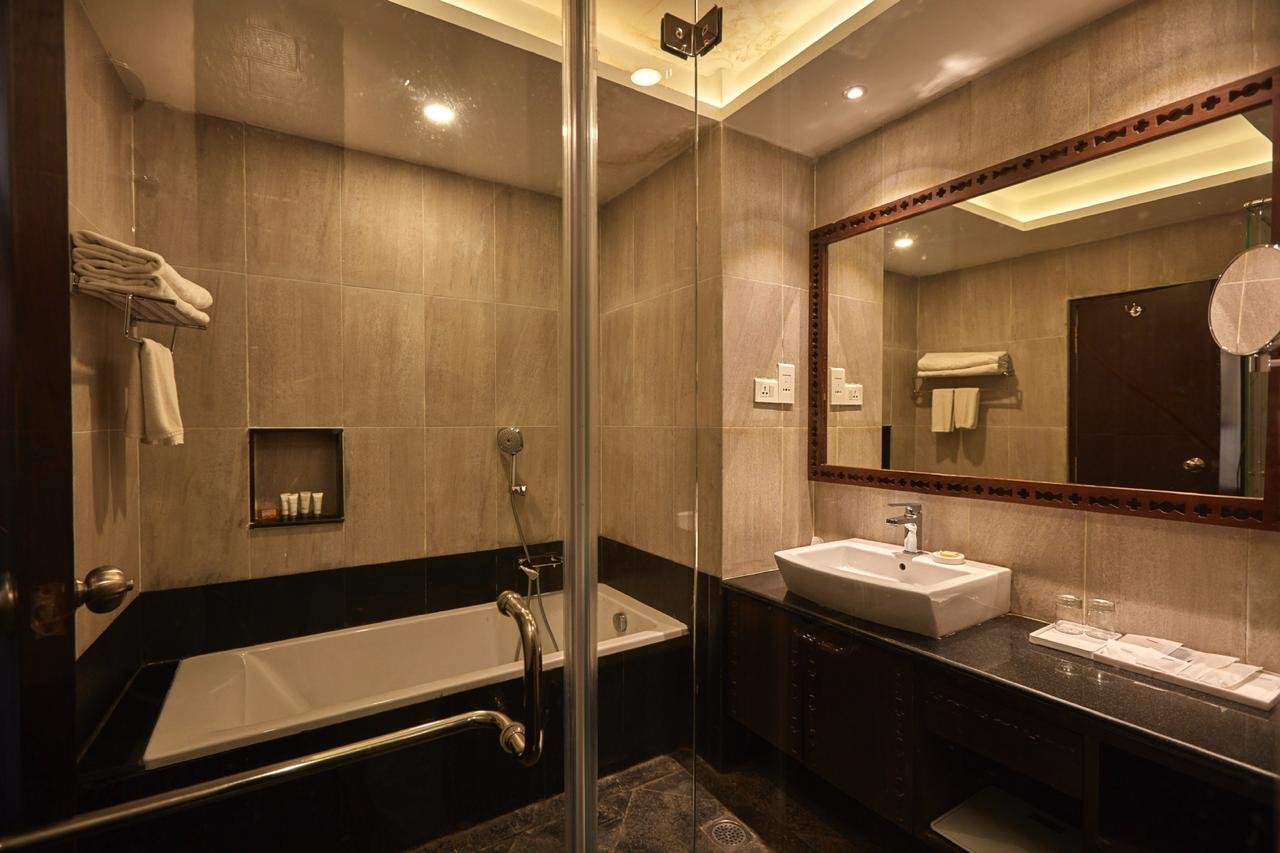 Deluxe King Room bathroom at Chandragiri Hills Resort