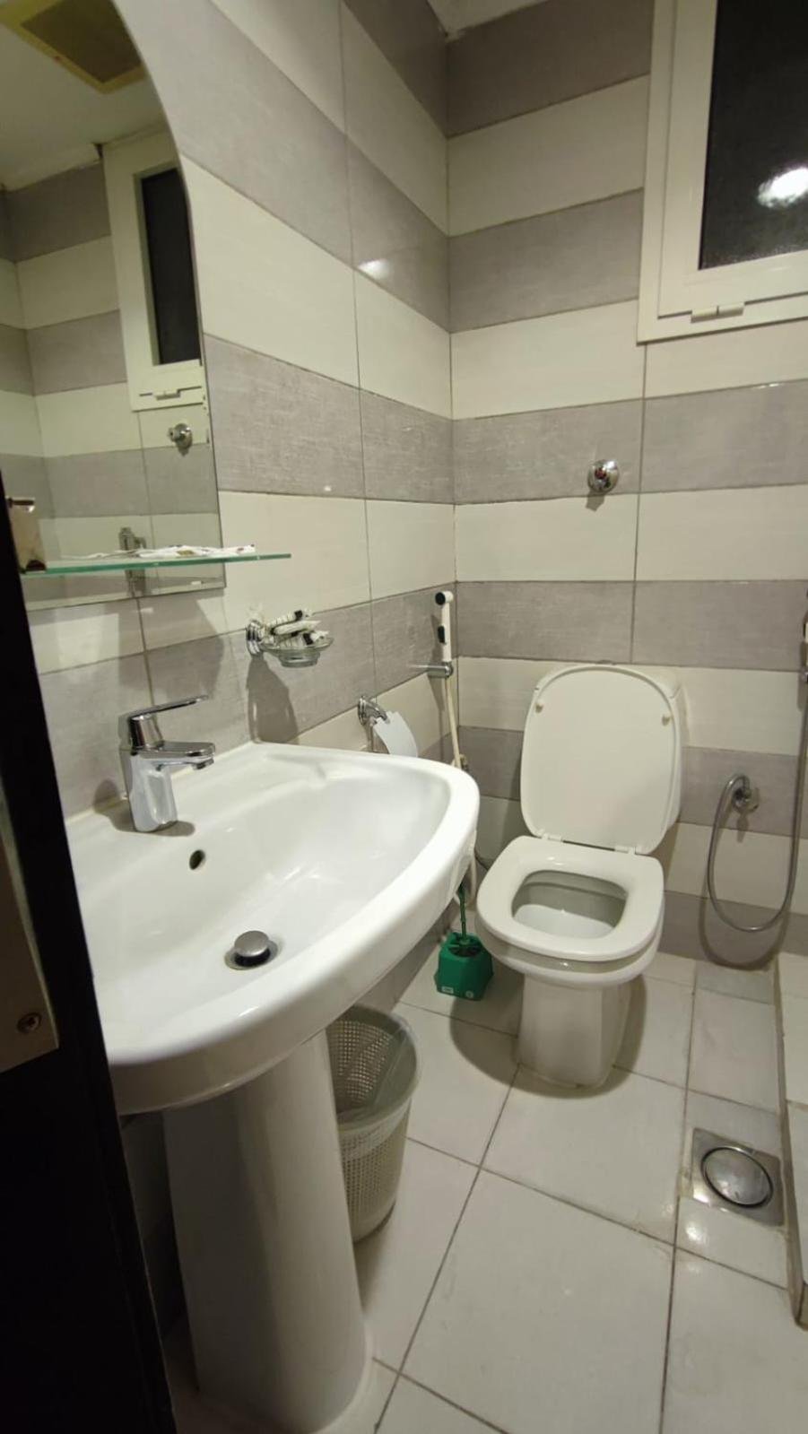 a bathroom with a sink and a toilet at Razana Al-Hafaer in Makkah