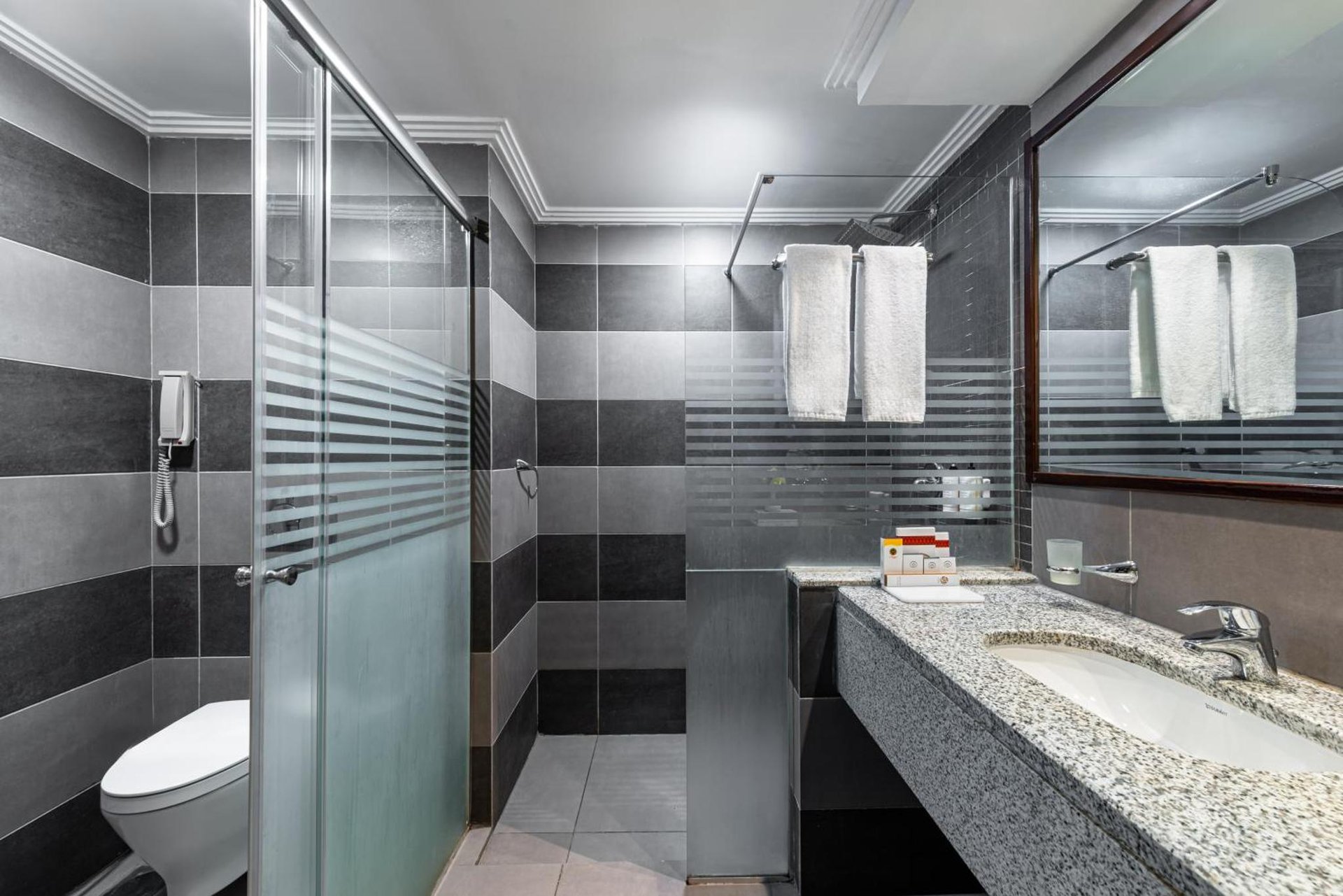 a bathroom with a sink and a toilet at Razana Al Rawdha Hotel in Mecca