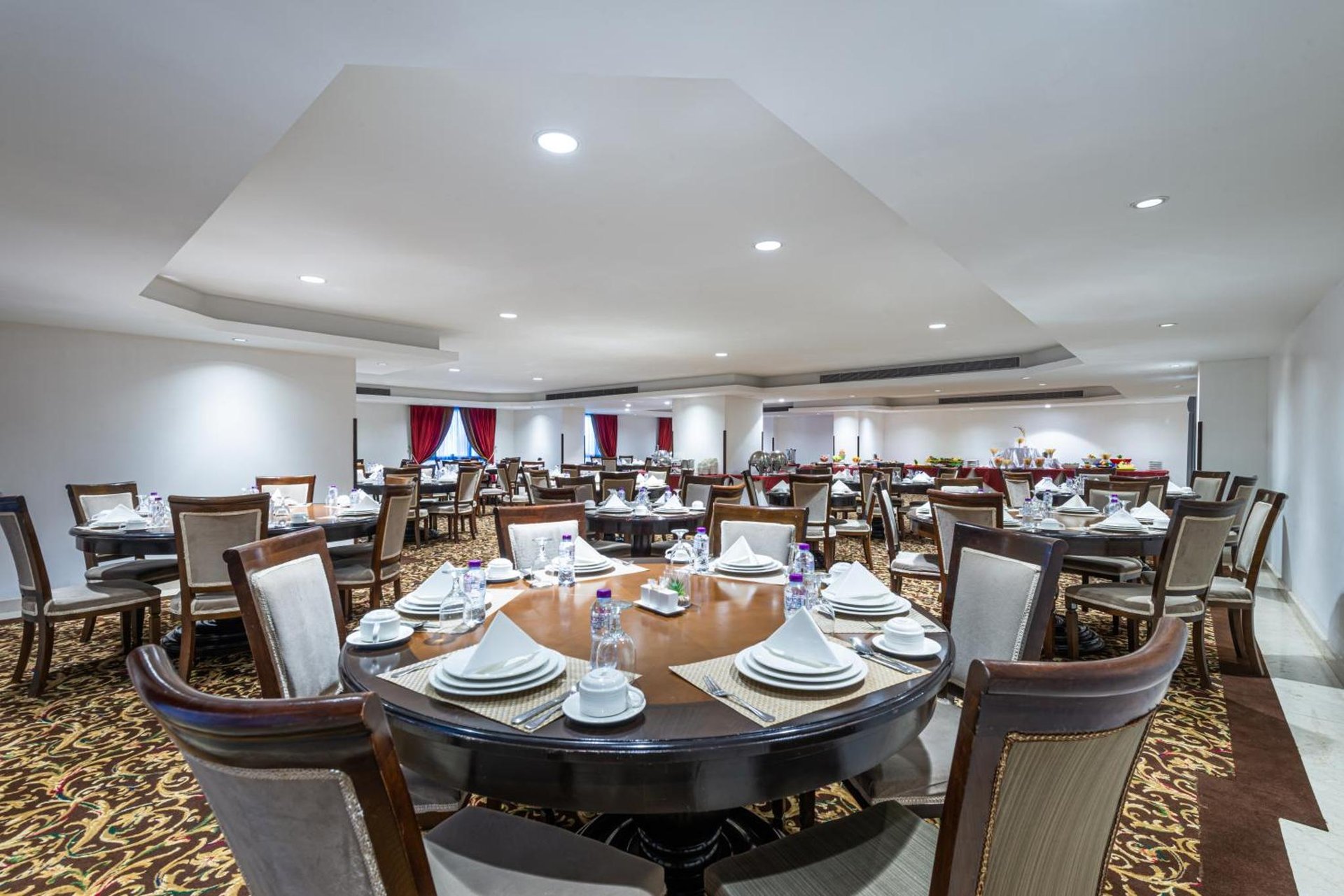 a dining room with a large table and chairs at Razana Al Rawdha Hotel in Mecca +40 photos