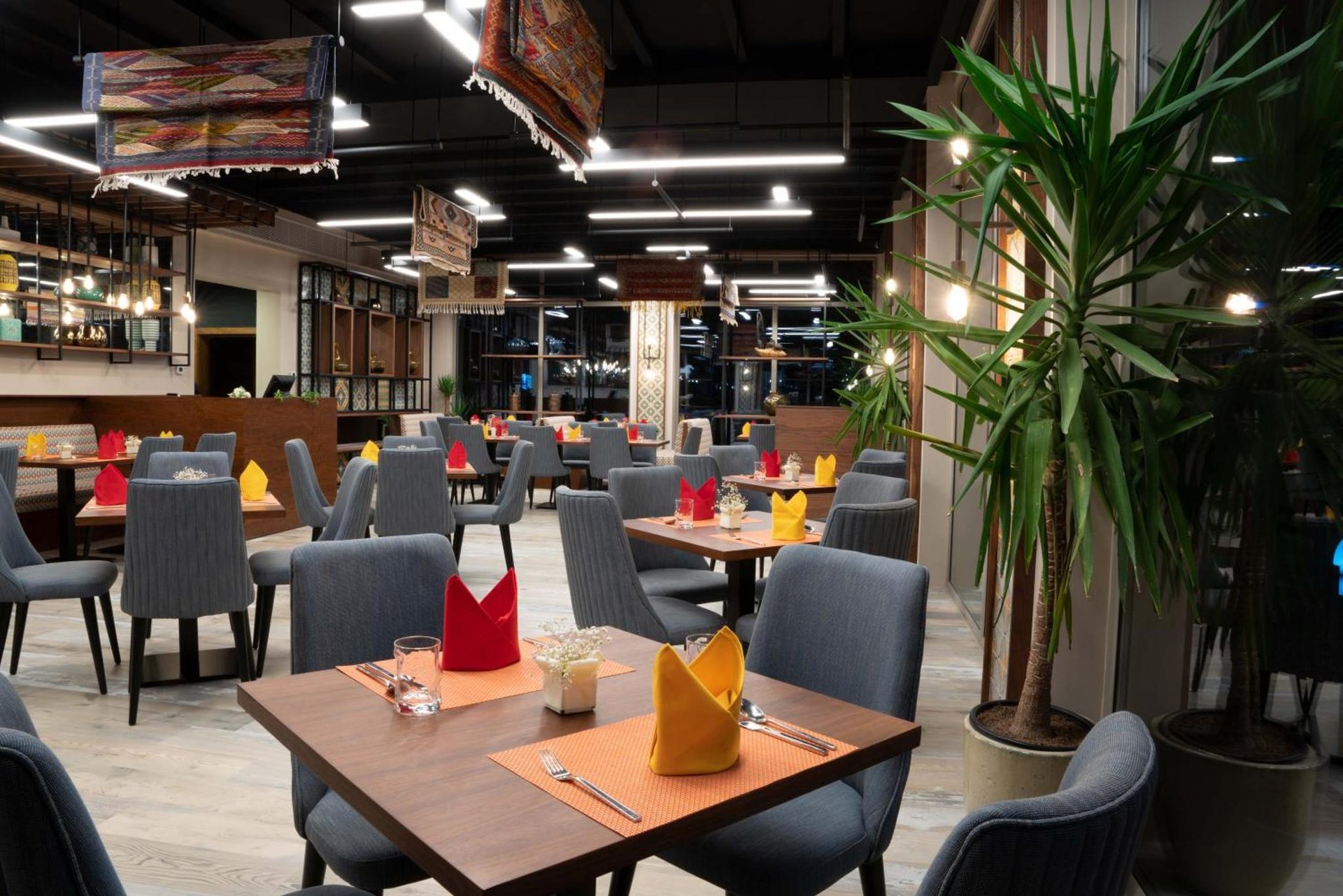 a dining room with tables and chairs and a restaurant at Jaw Resort & Spa in Manama