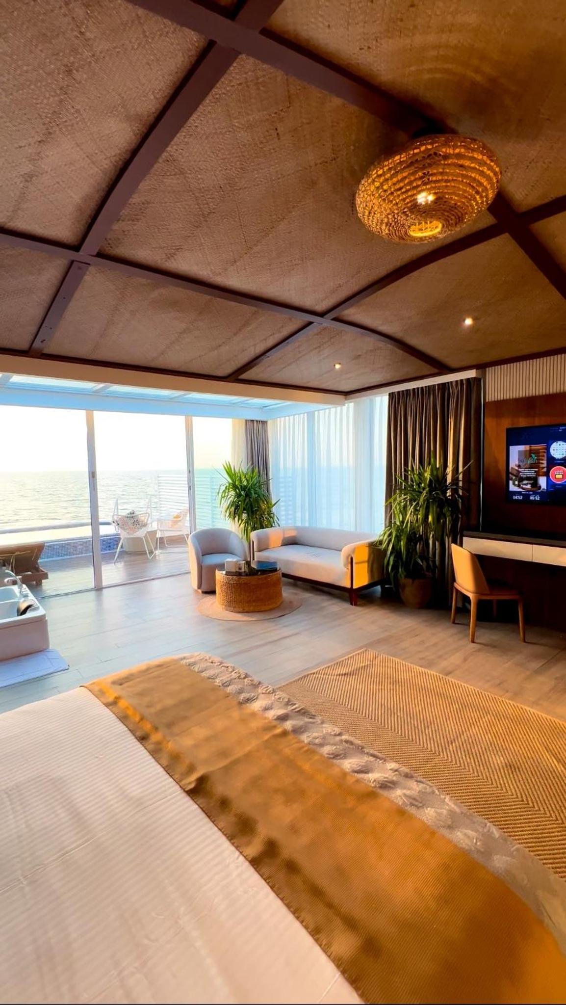 a large living room with a couch and a tv at Jaw Resort & Spa in Manama