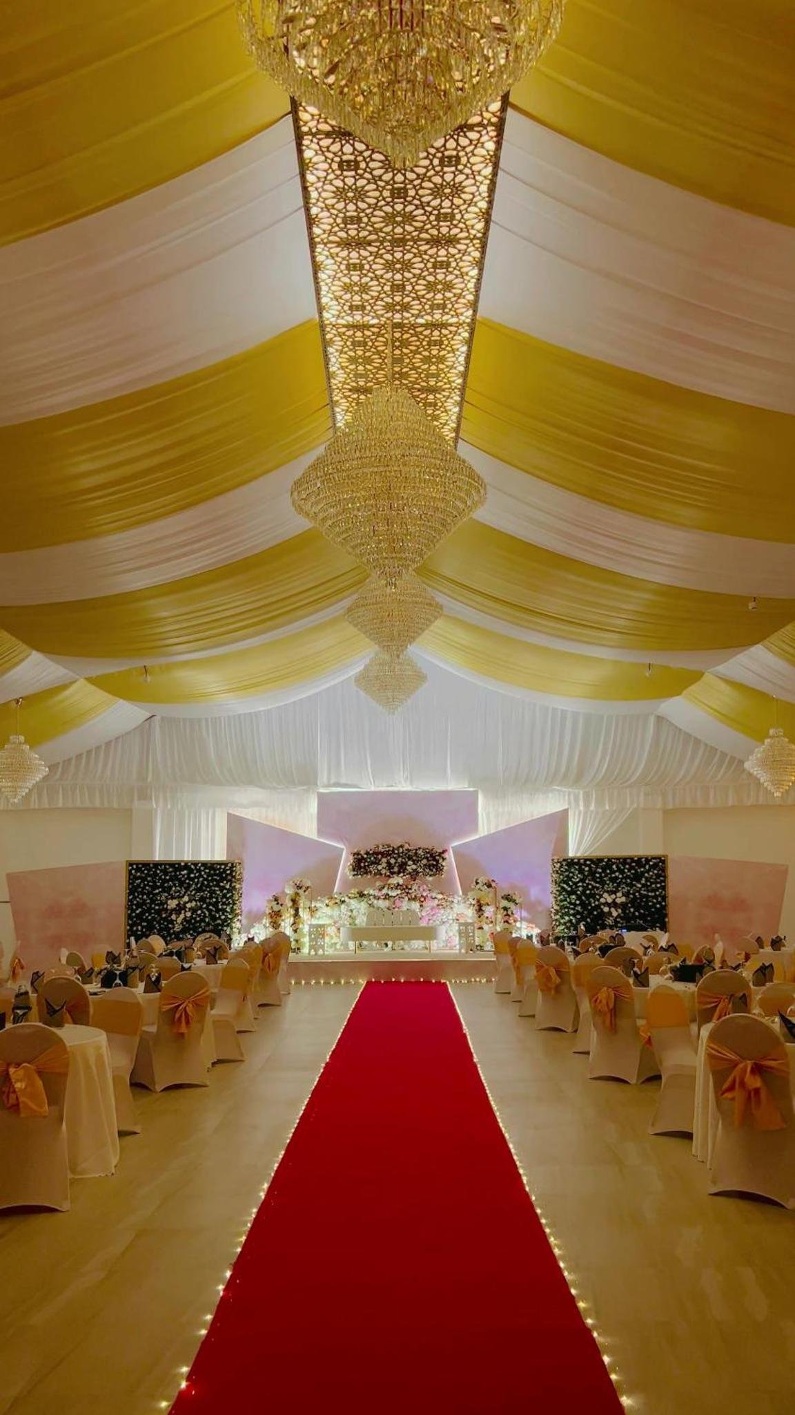 a large banquet hall with a red carpet and chairs at Jaw Resort & Spa in Manama +105 photos
