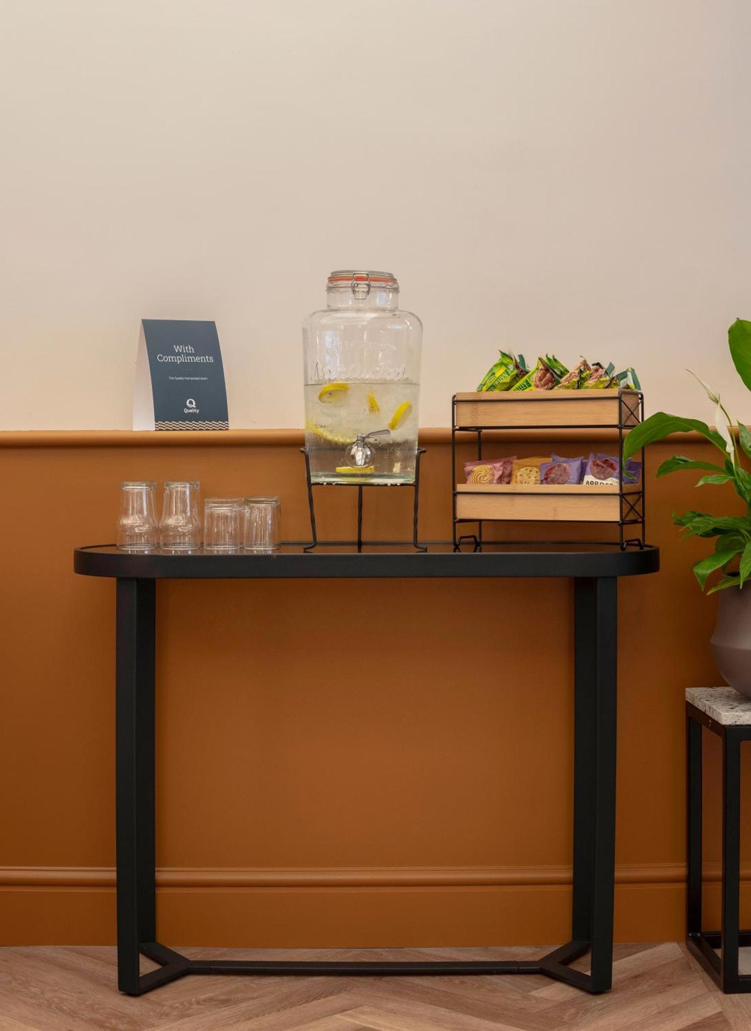 a table with a bowl of water and glasses on it at Quality Hotel Hampstead in London