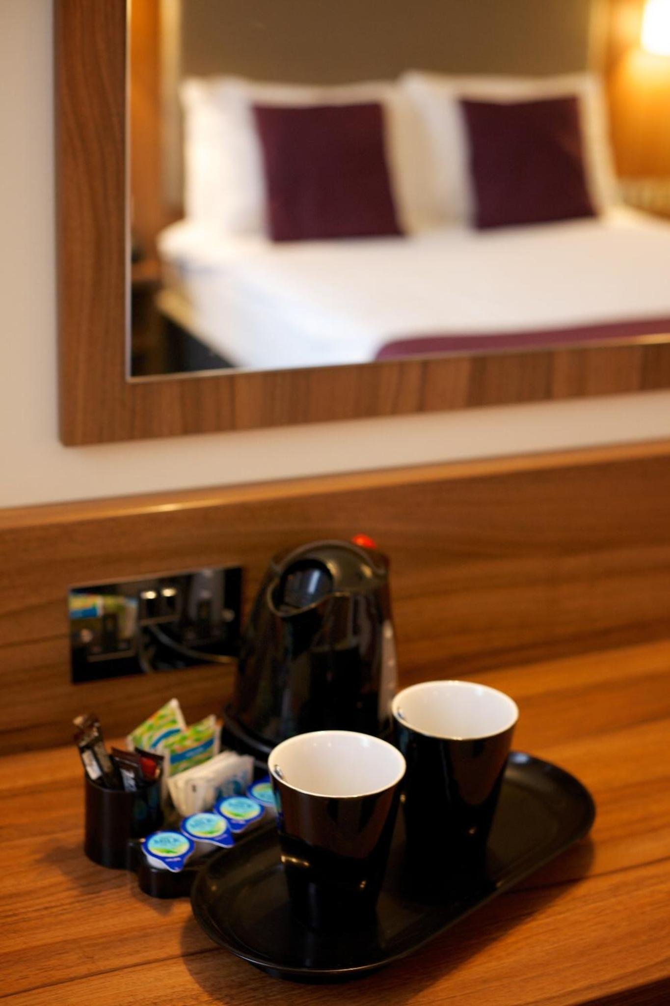 a tray with two cups on a table in a hotel room at Quality Hotel Hampstead in London