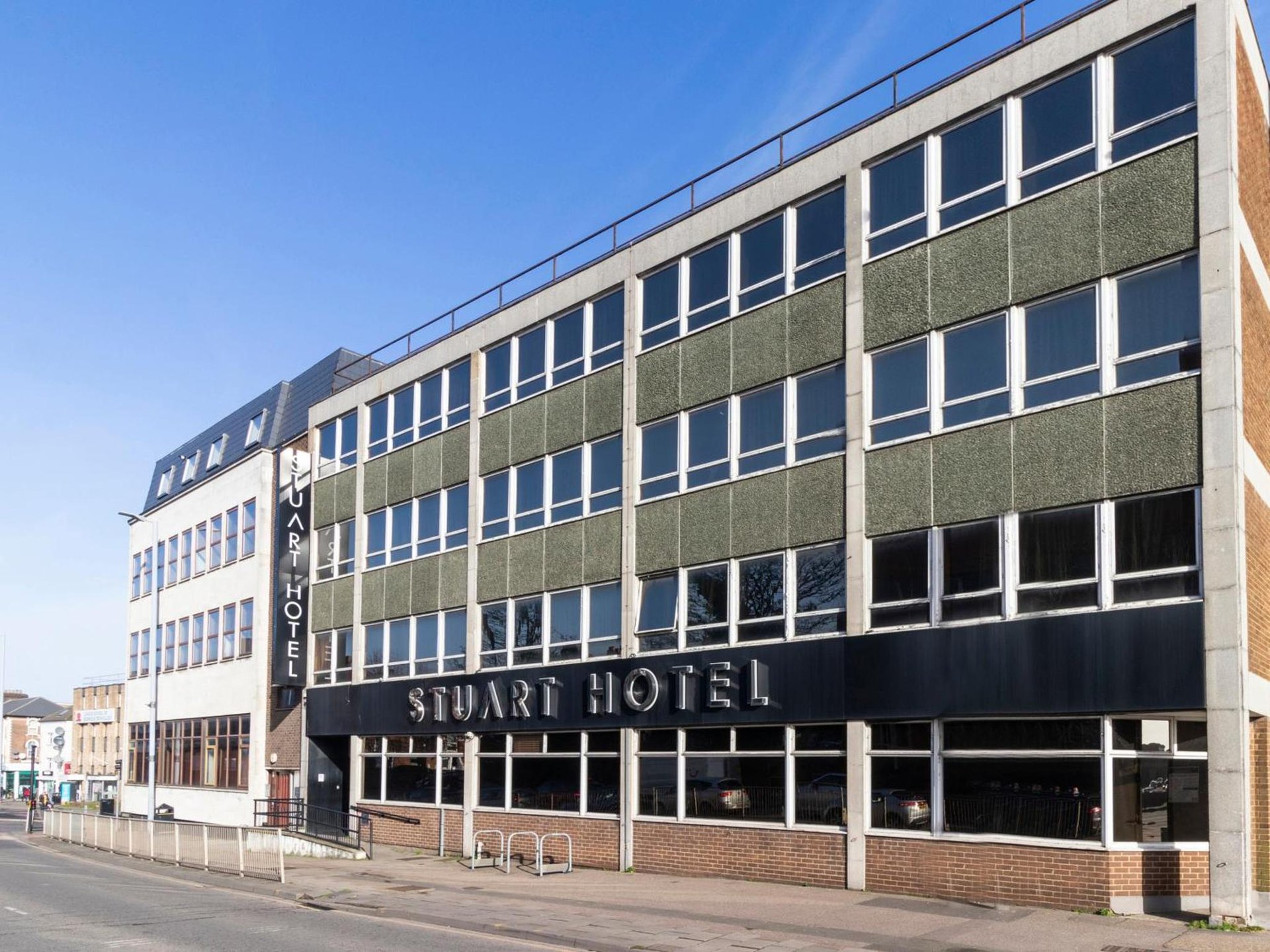 a building with a sign that reads smart hotel at Stuart Hotel in Luton
