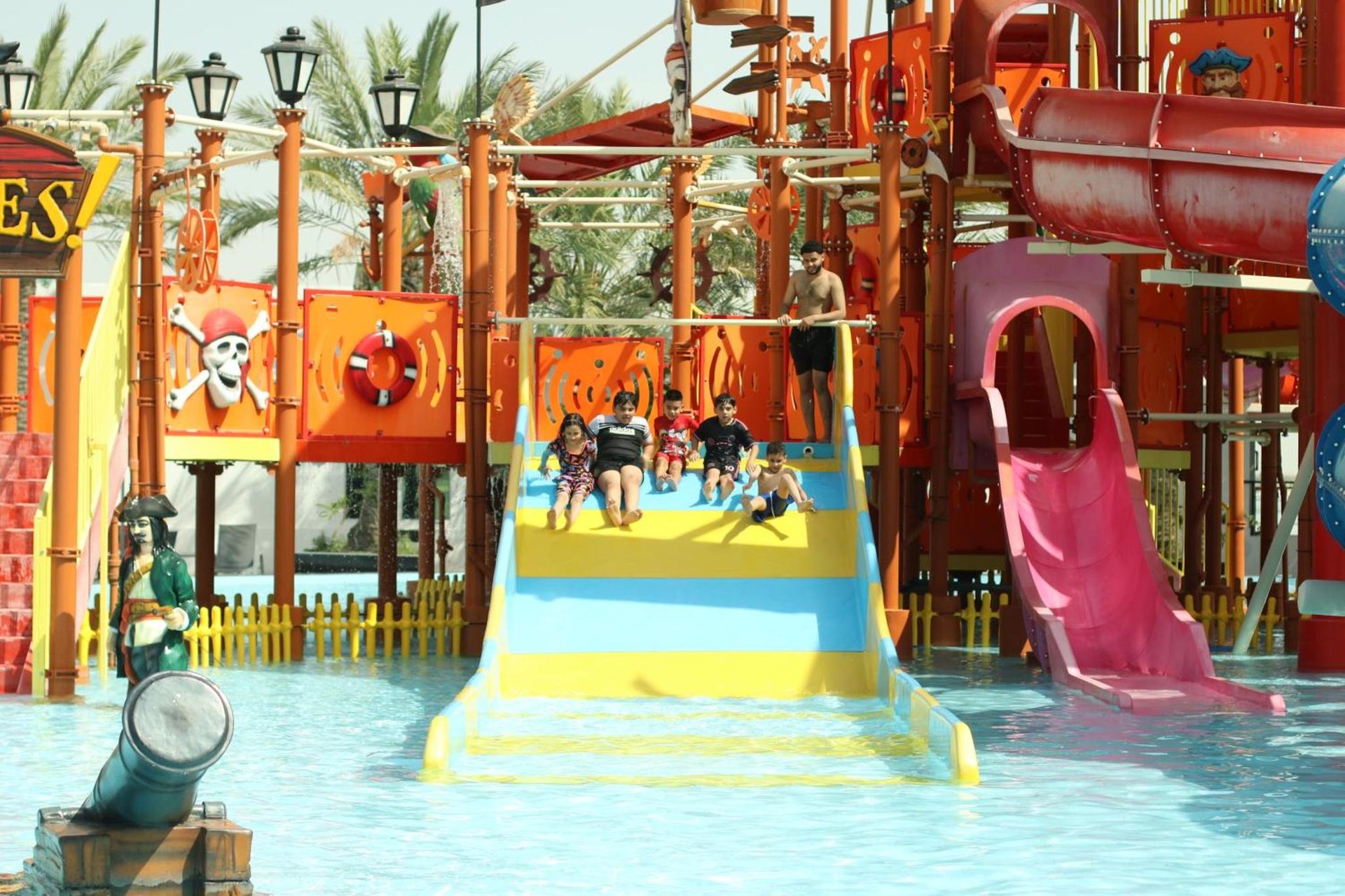 a group of people on a water slide at a water park at Lagoona Beach Luxury Resort and Spa in Manama