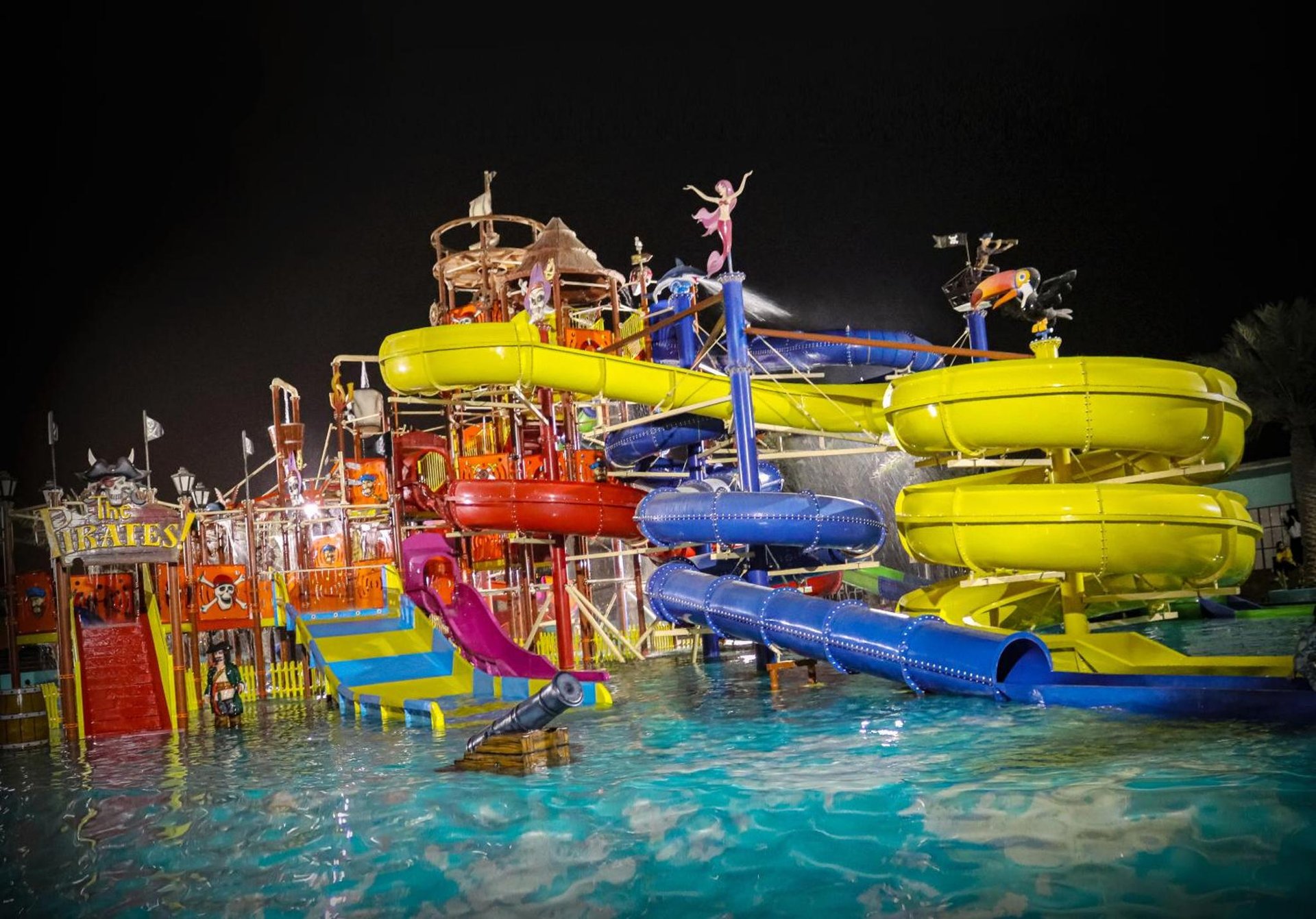 a water park with a water slide in the water at Lagoona Beach Luxury Resort and Spa in Manama