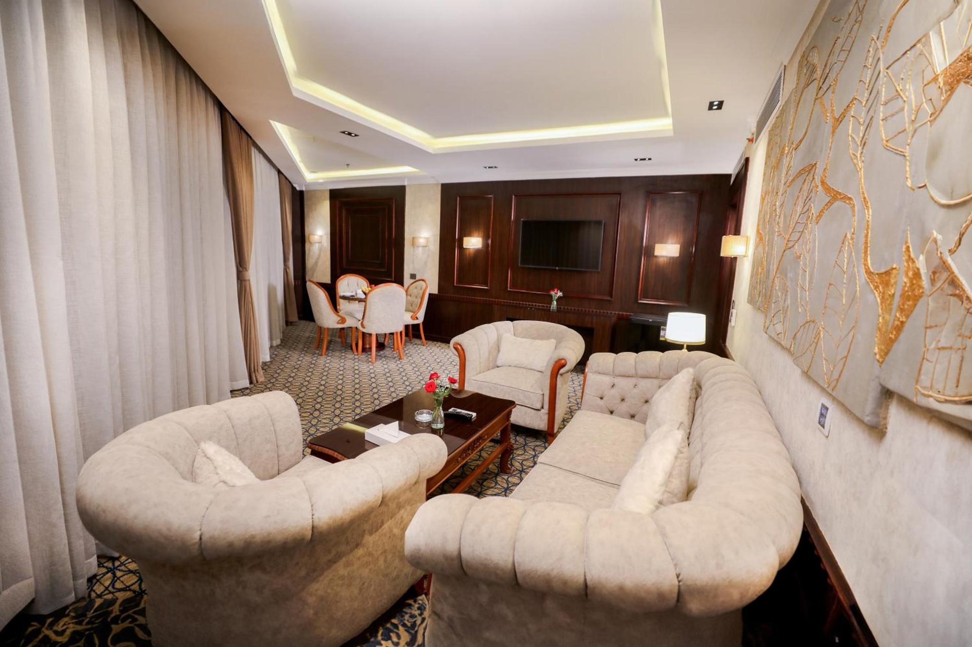 a living room with two couches and a table at Cairo Taj Hotels & Suites- Mohandessin in Cairo