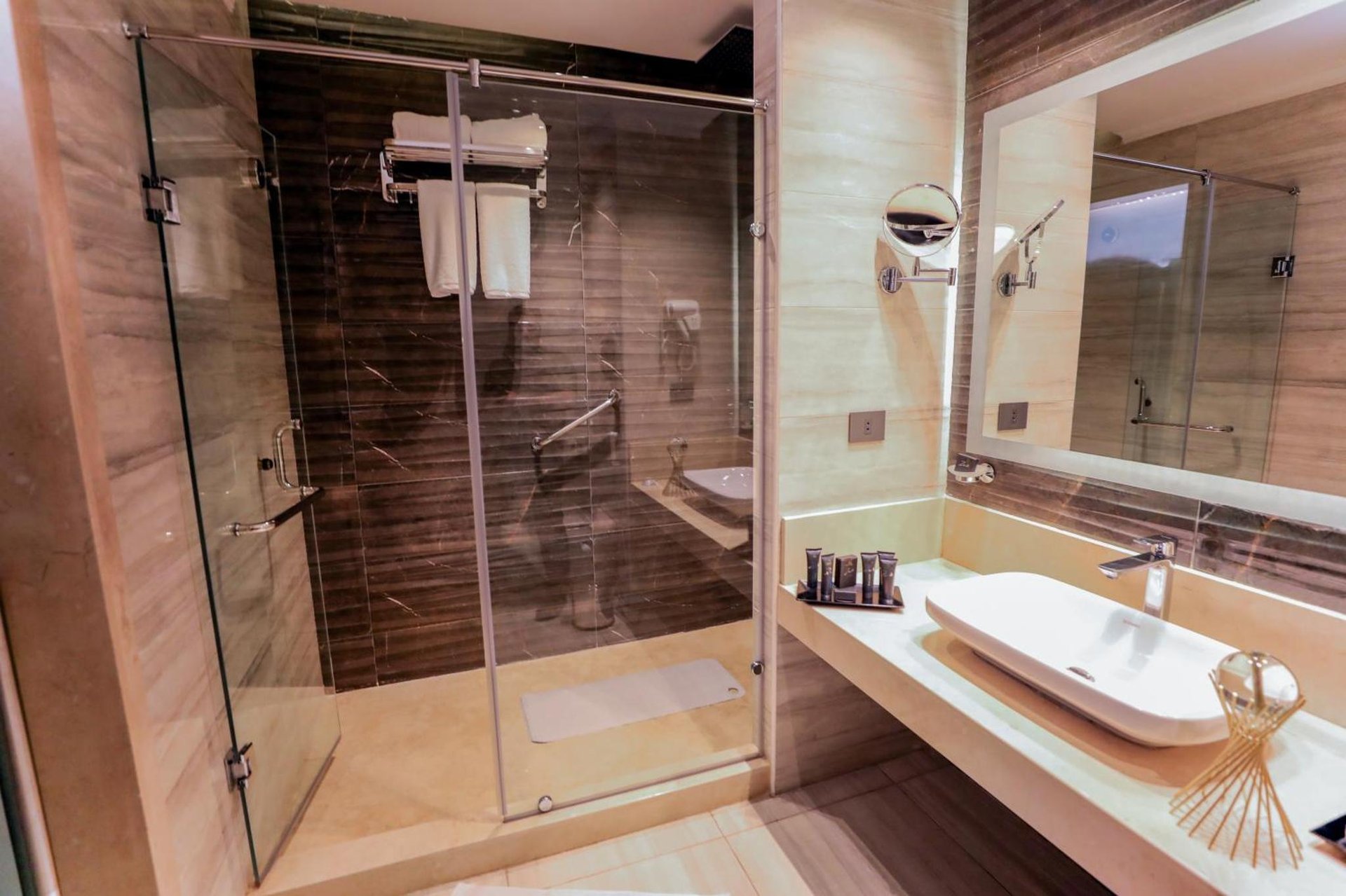 a bathroom with a shower and a sink at Cairo Taj Hotels & Suites- Mohandessin in Cairo