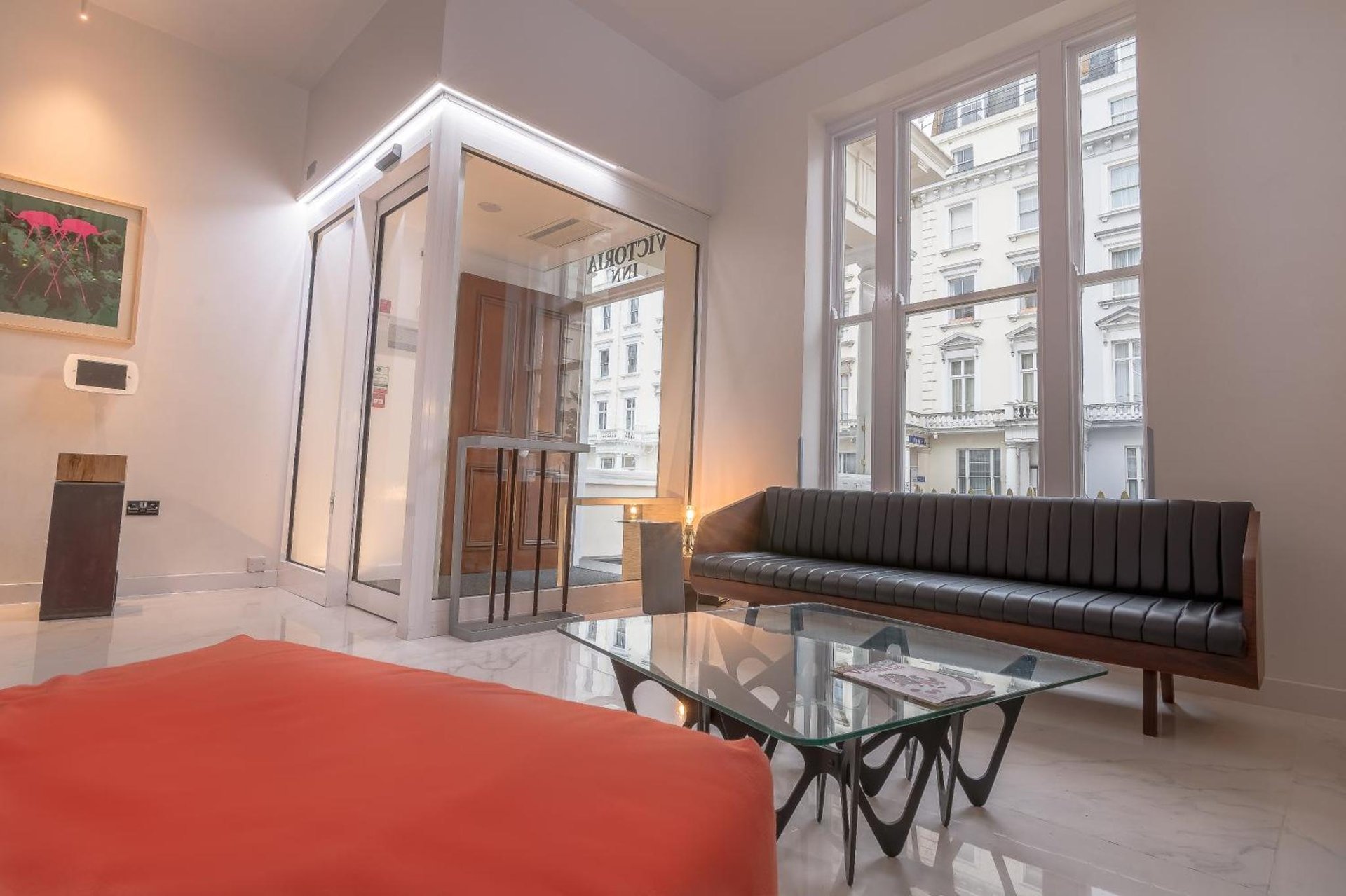 a living room with a couch and a table at Victoria Inn London in London