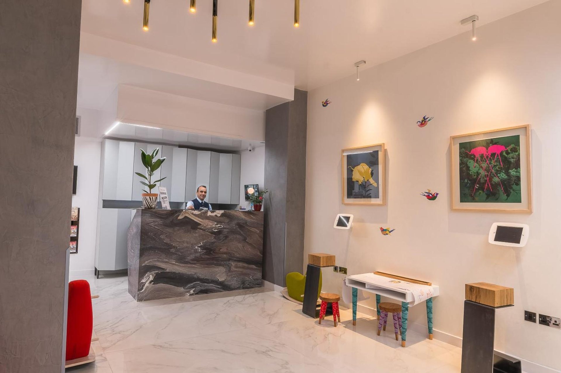 a man standing at a counter in a room with a table at Victoria Inn London in London +21 photos
