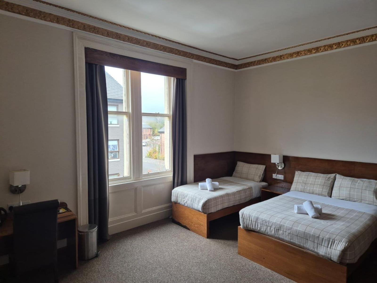 a hotel room with two beds and a window at Douglas Hotel in Glasgow