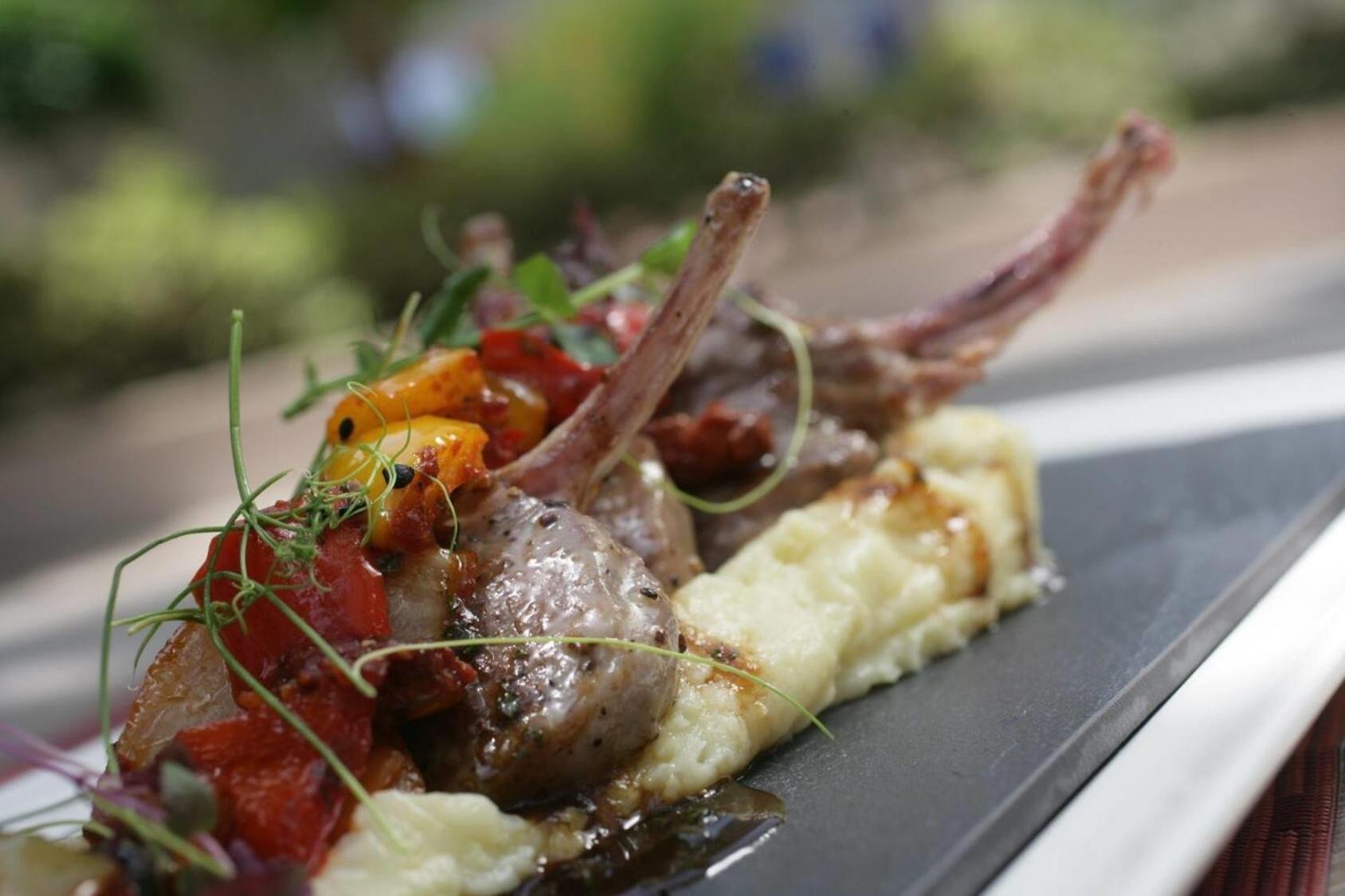 a plate of food with meat and vegetables on it at Ramada by Wyndham Downtown Dubai in Dubai