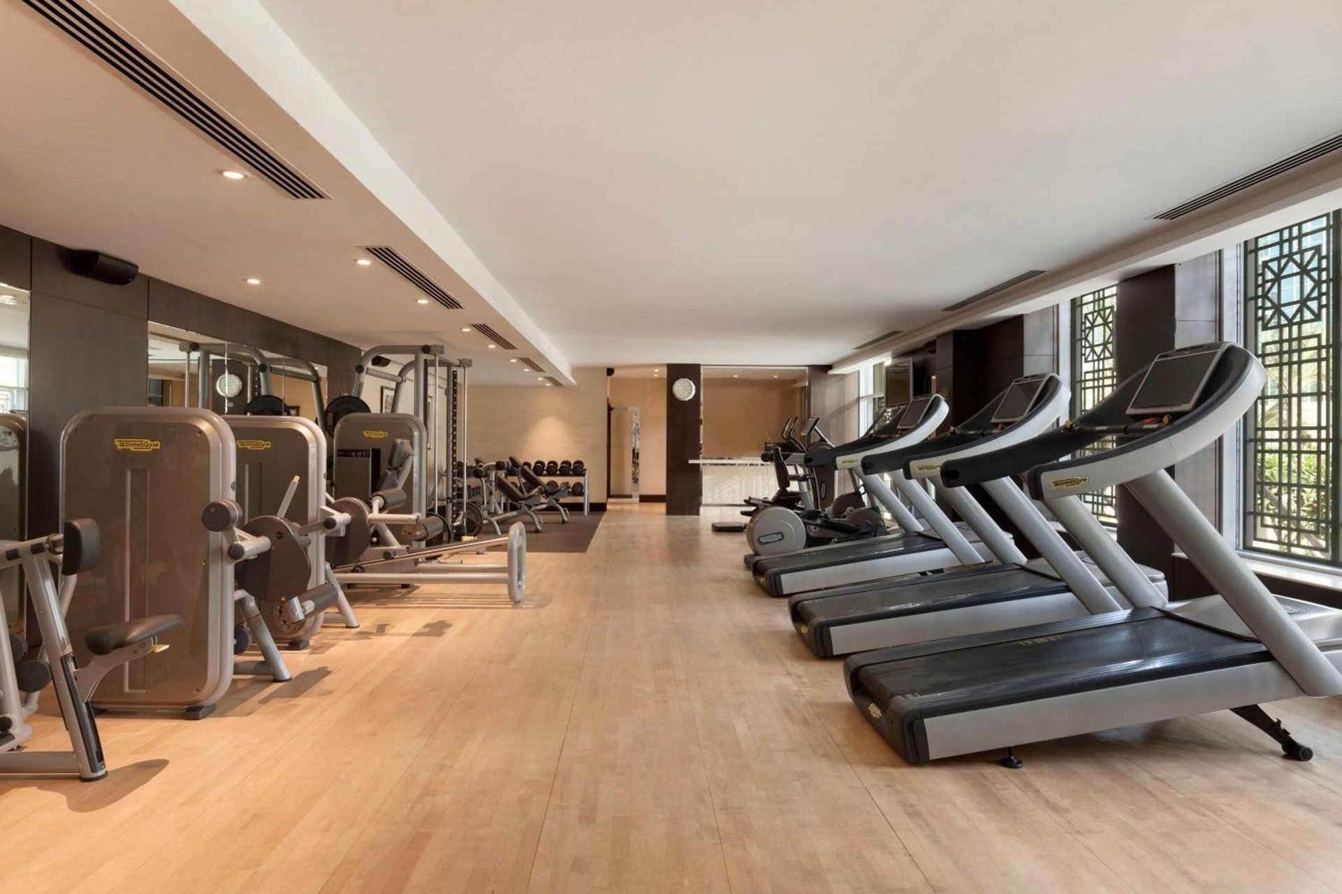 a gym with a row of treadmills at Ramada by Wyndham Downtown Dubai in Dubai