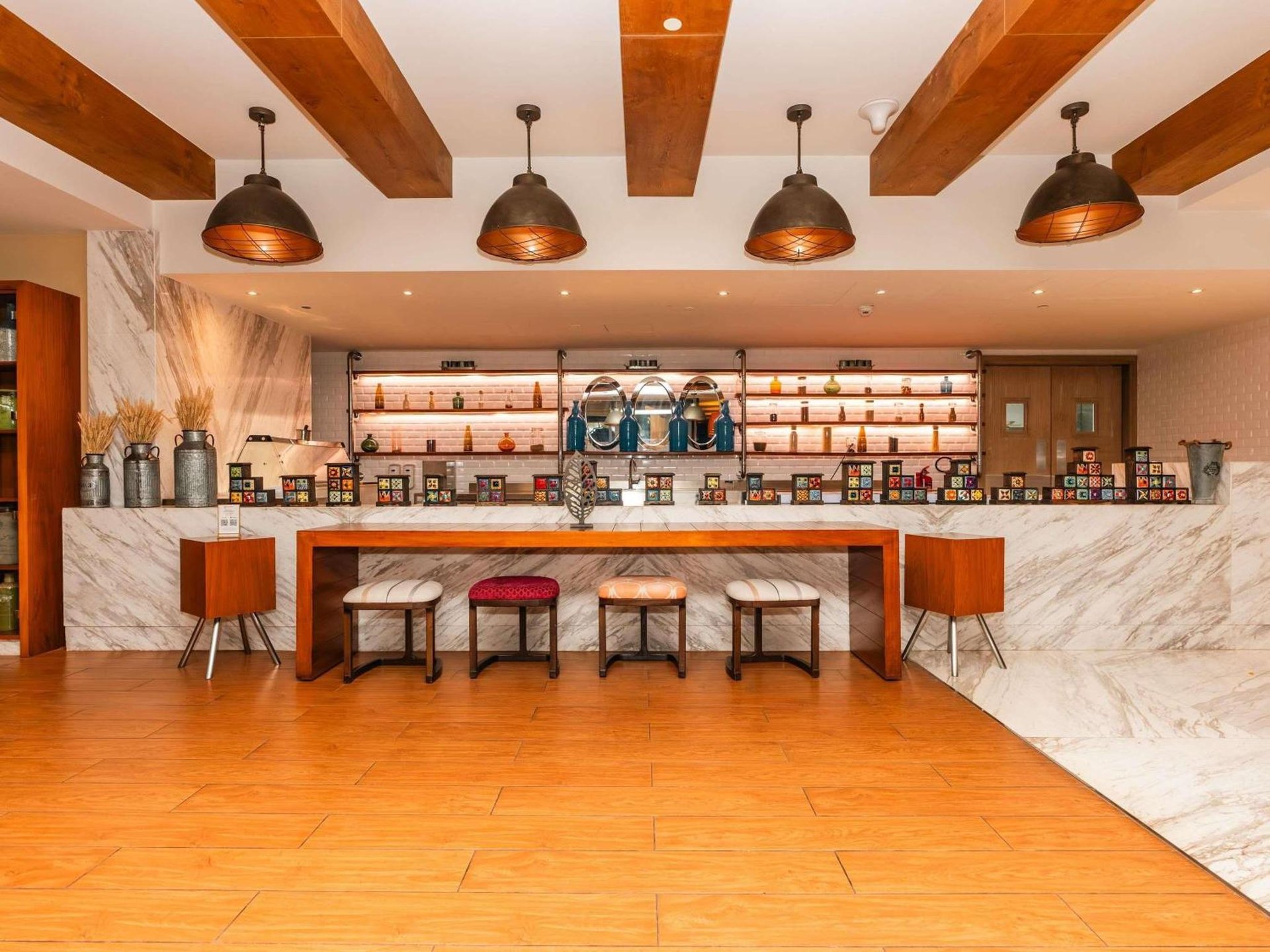 a large kitchen with a counter with stools at The Retreat Palm Dubai MGallery by Sofitel in Dubai
