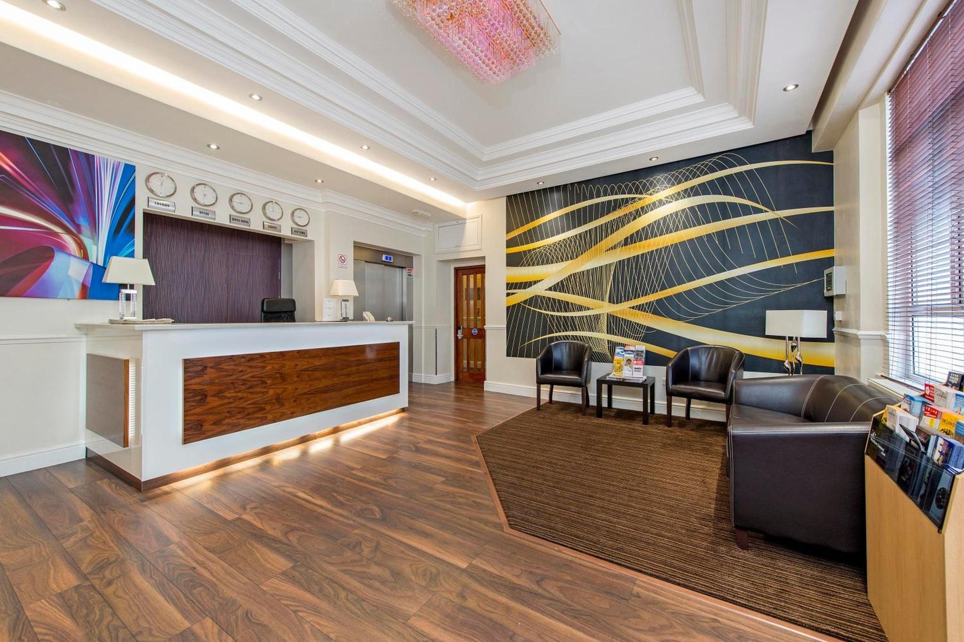 a living room with a couch and a stage at Lidos Hotel in London