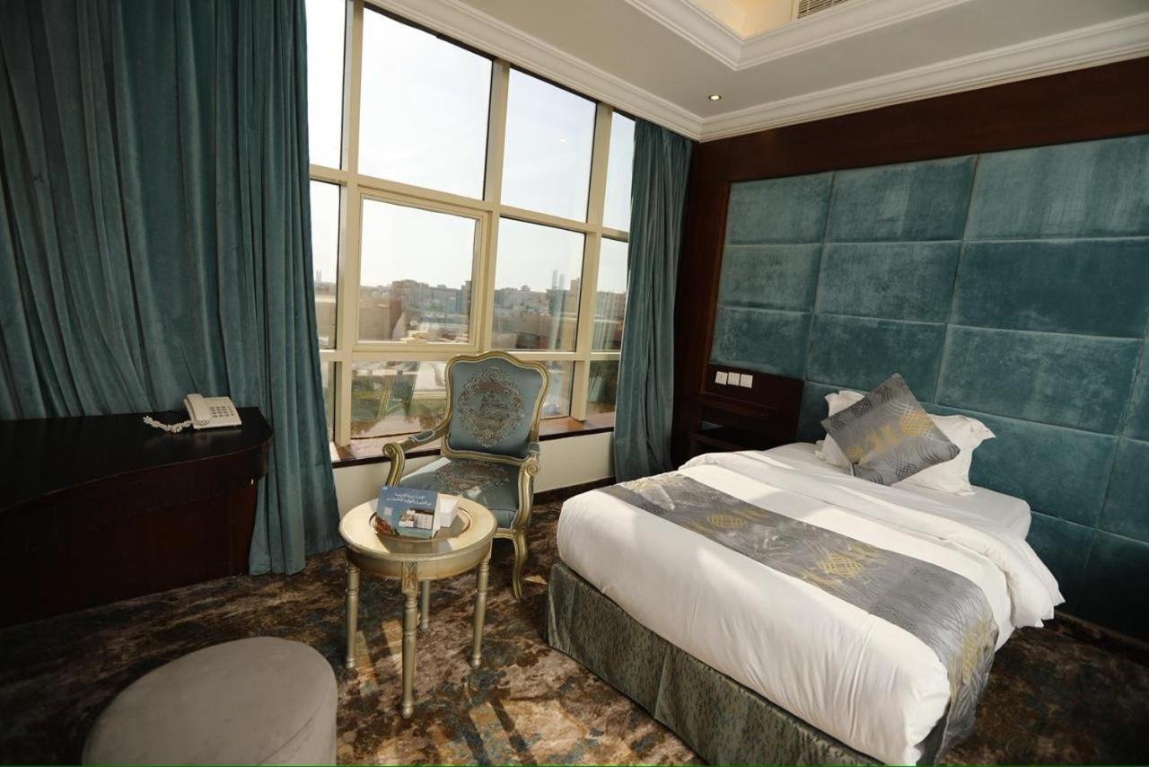 a hotel room with a bed and a chair at Three Points Al Salama in Jeddah